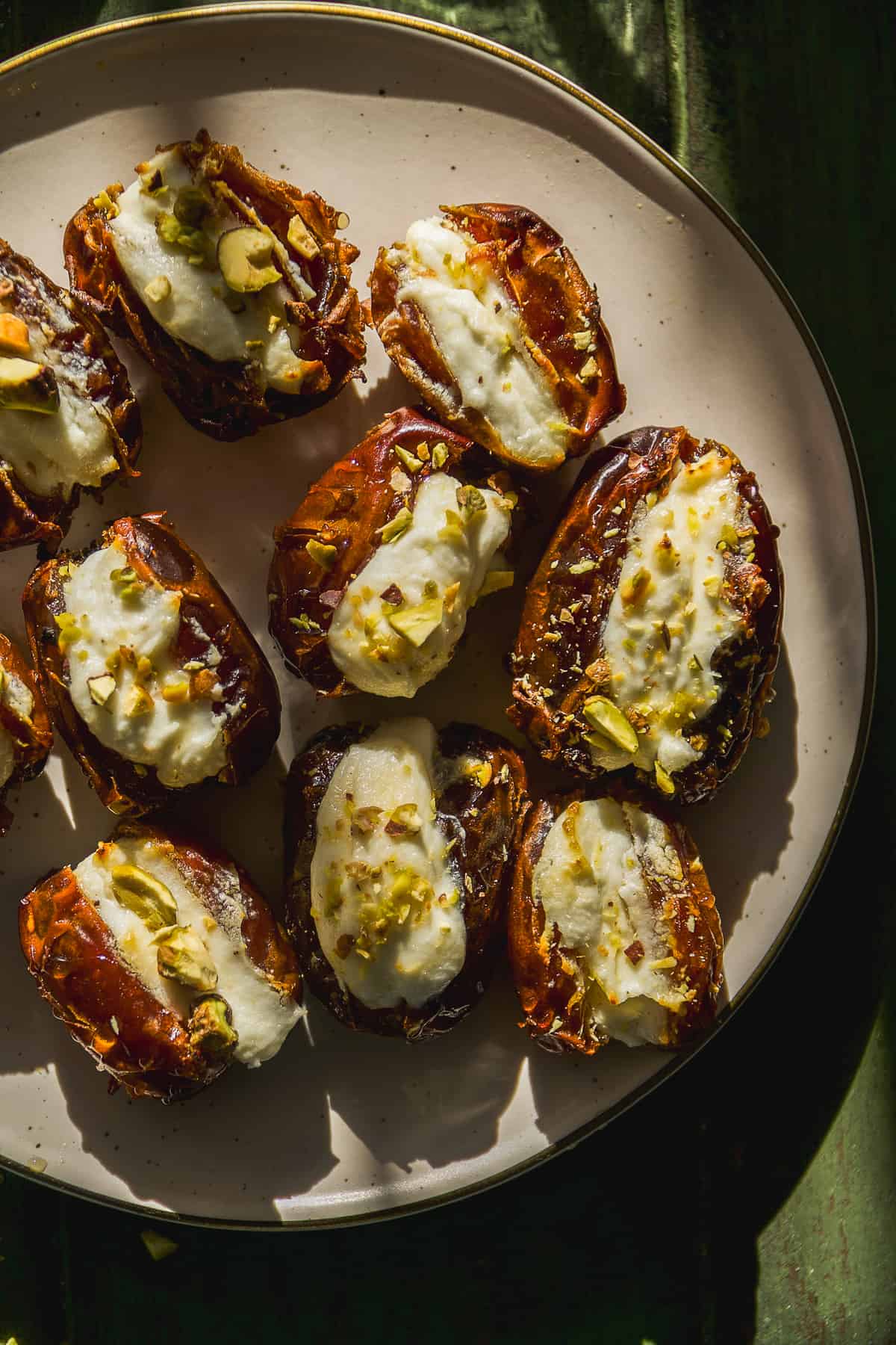 Dates stuffed with goat cheese with pistachios on top.