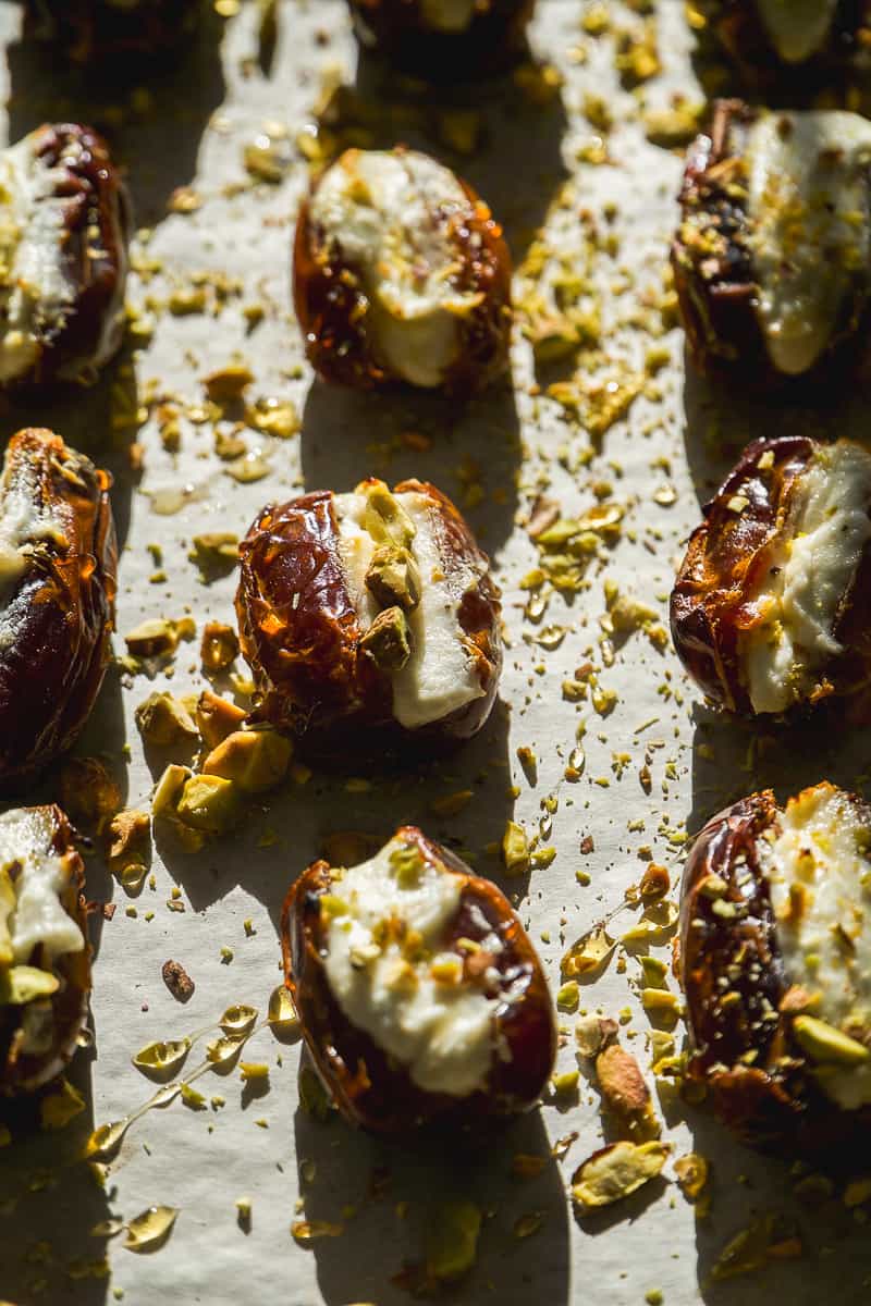 Stuffed dates with goat cheese on a baking sheet.