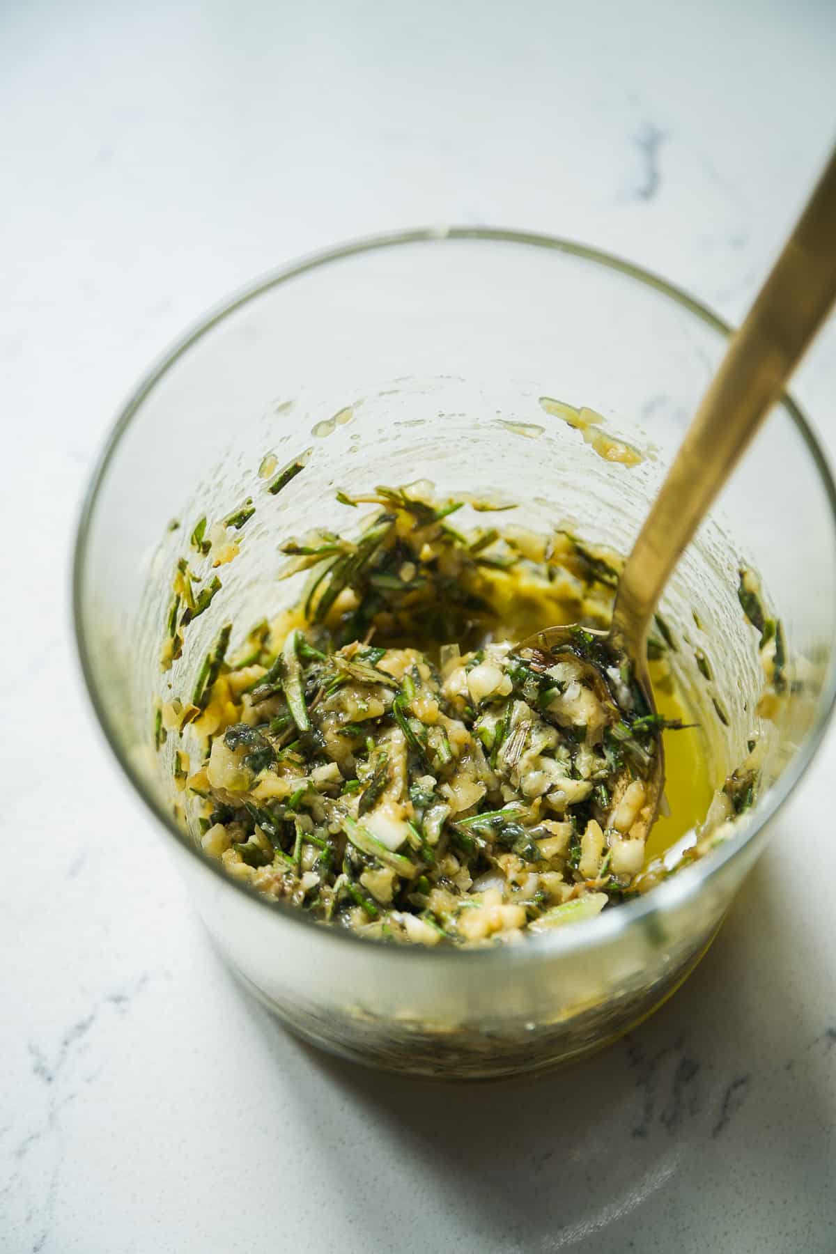 Garlic and herb coating in a glass jar.