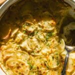 Round dish with goat cheese sauce and scalloped potatoes.