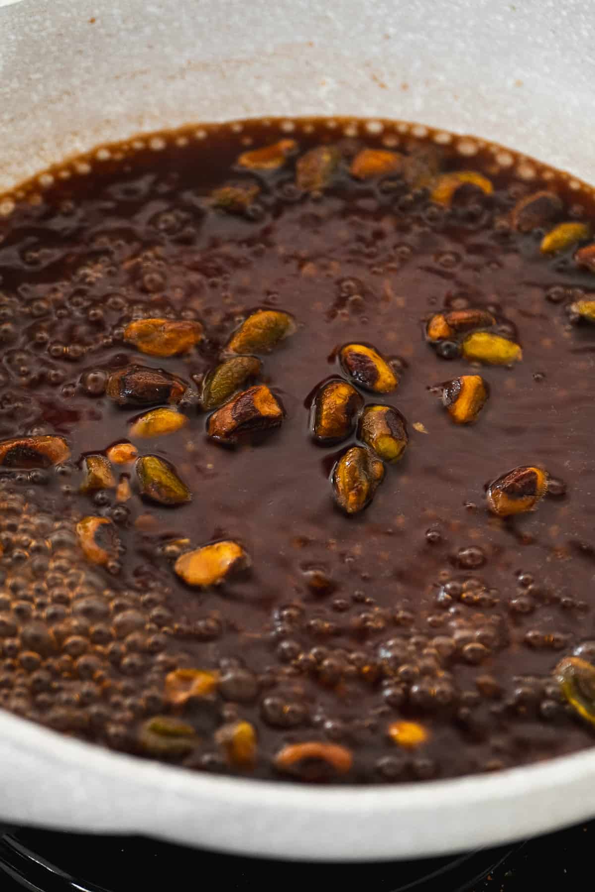 Pistachio butter syrup simmering in a saucepan.