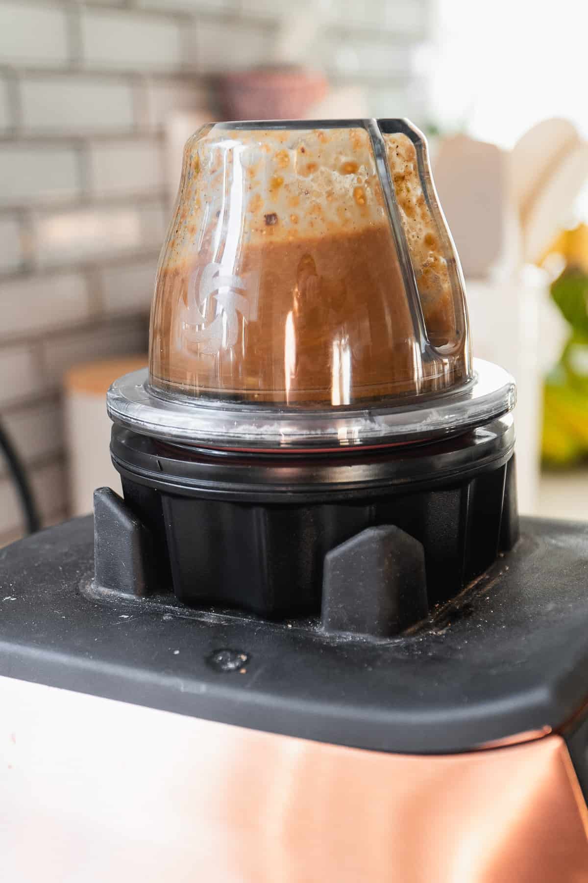 Pistachio butter syrup being blended in a small blender.