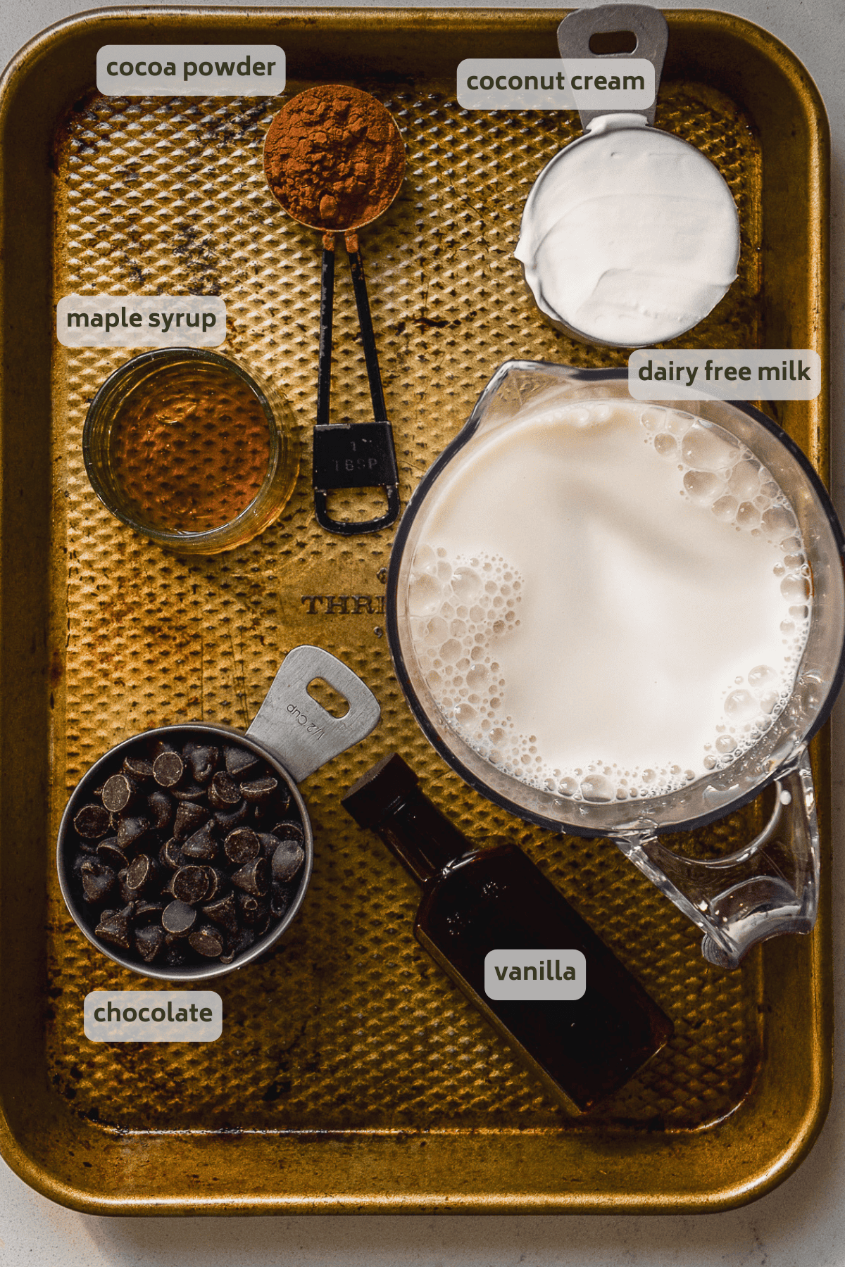 Dairy free hot chocolate ingredients on a baking sheet with labels.