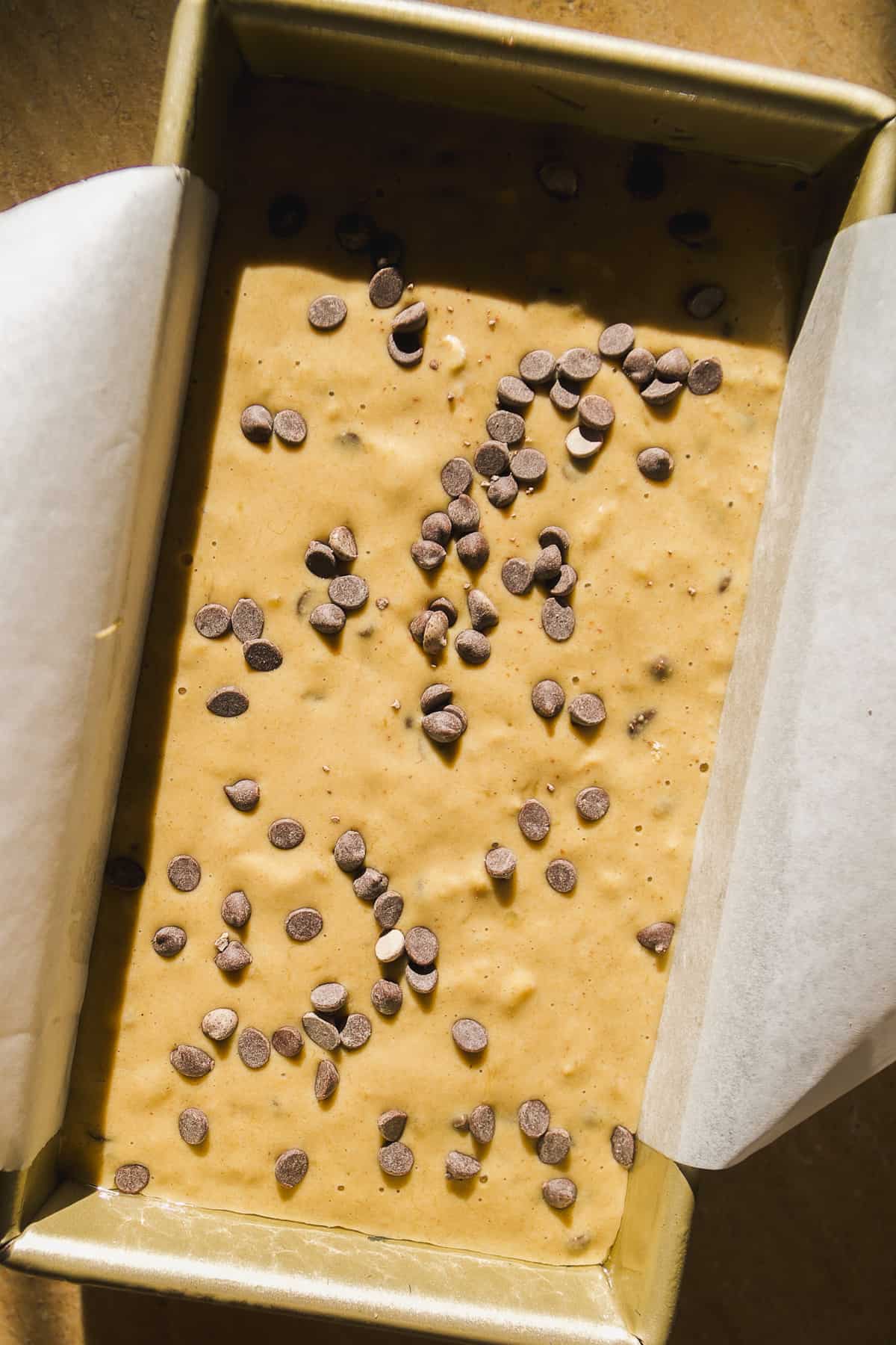 Oatmeal banana bread in a loaf pan about to be baked.