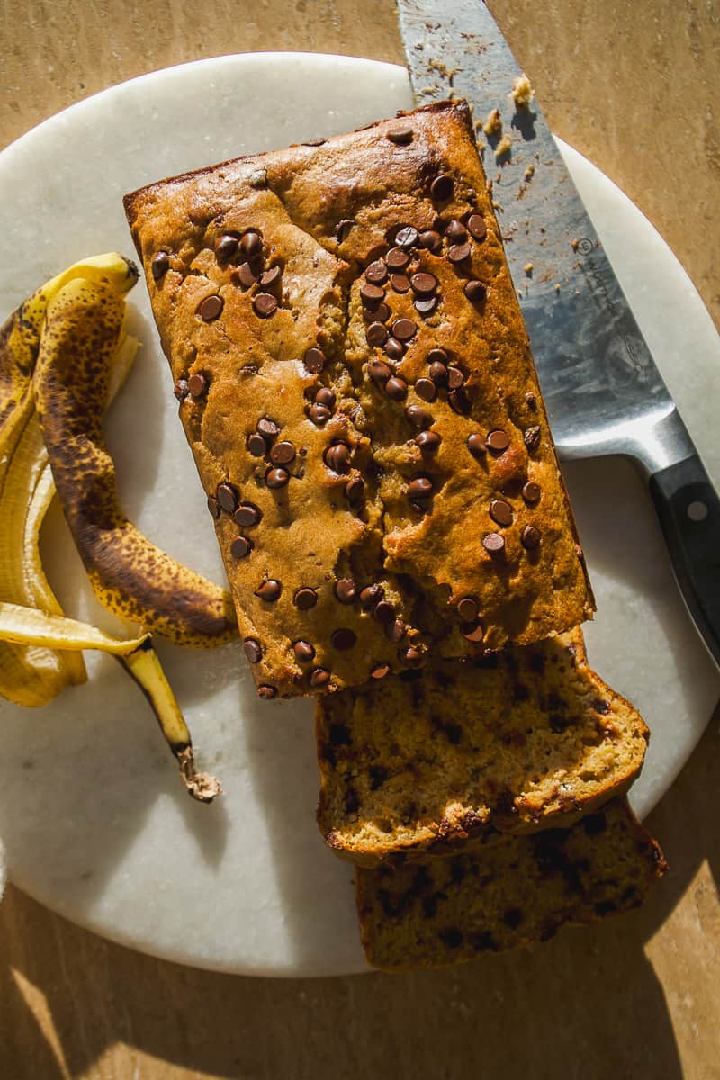 Oat flour banana bread on a platter with chocolate chips.