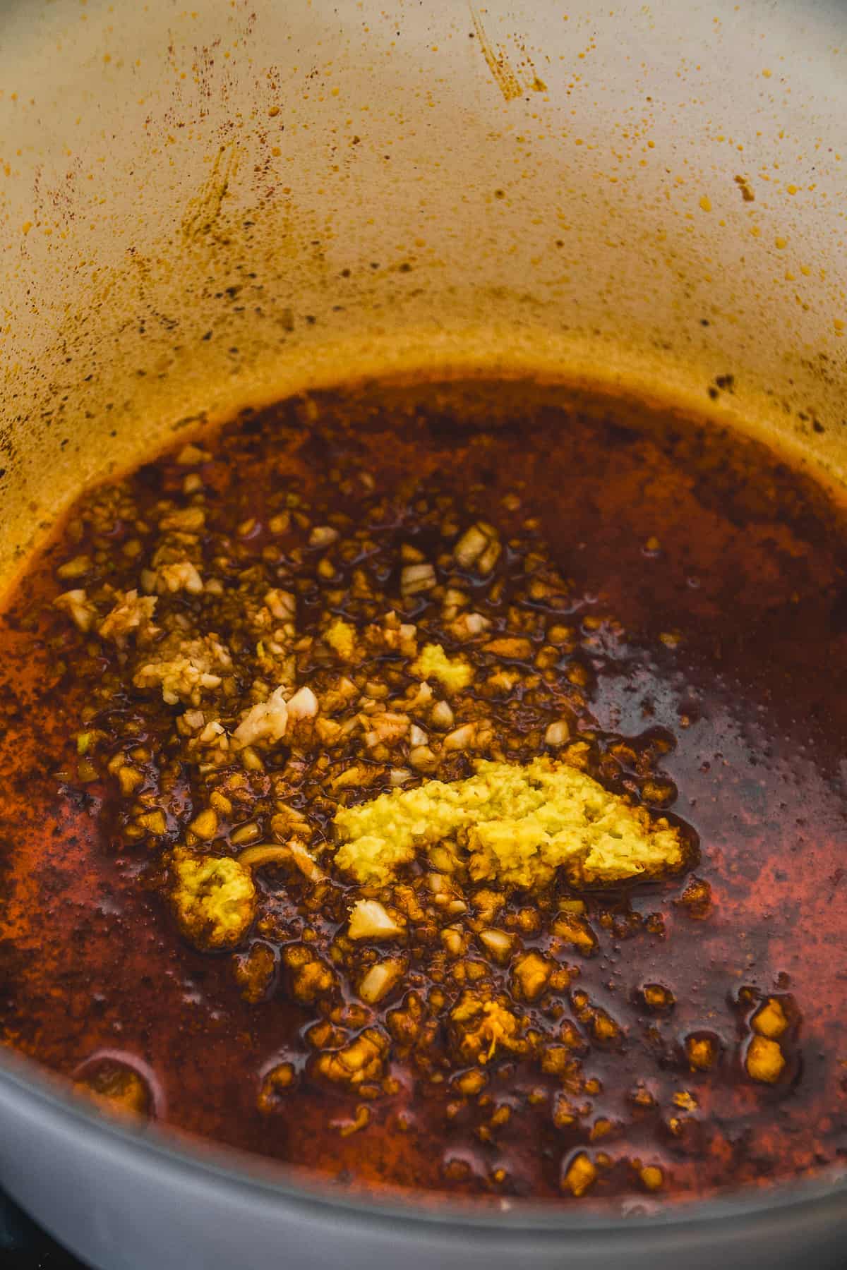 Ginger simmering in the bottom of a pot.