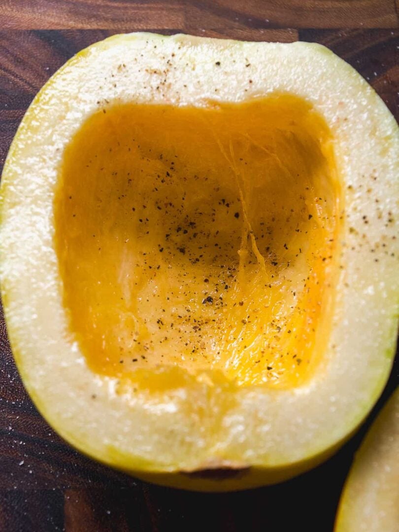 Spaghetti squash with olive oil, salt, and pepper about be roasted.