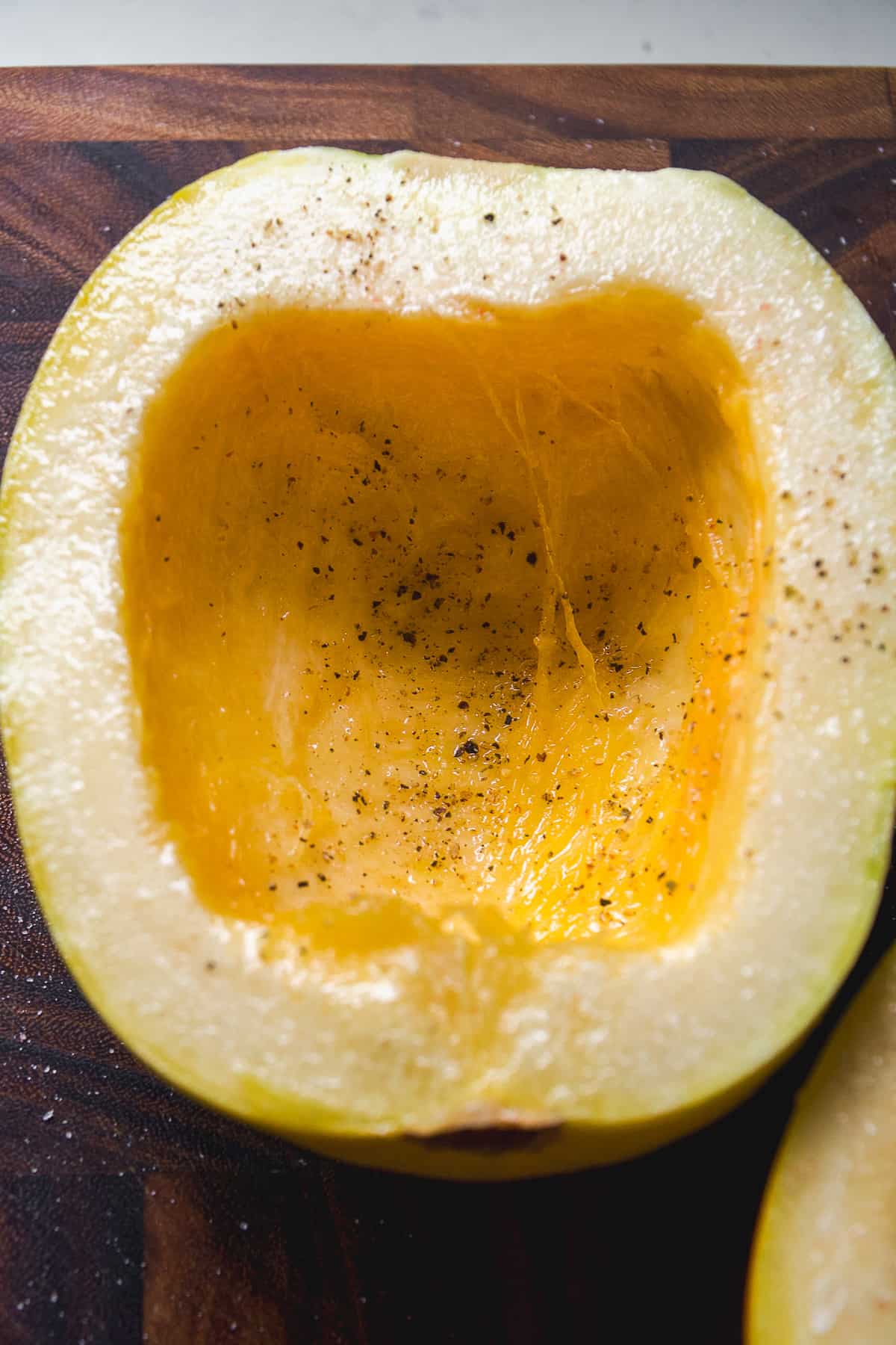 Spaghetti squash with olive oil, salt, and pepper about be roasted.