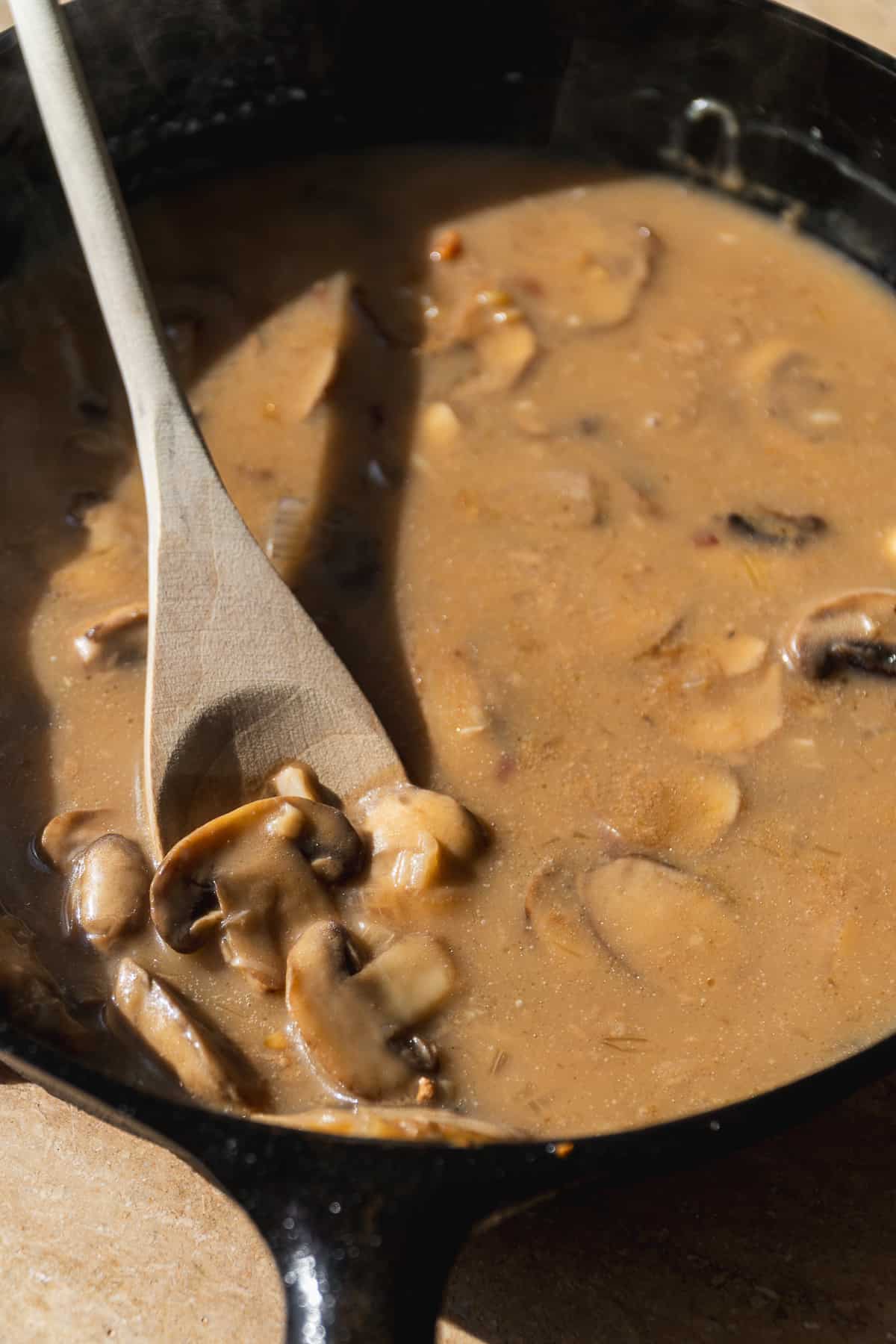 Marsala chicken sauce with mushrooms in a skillet.