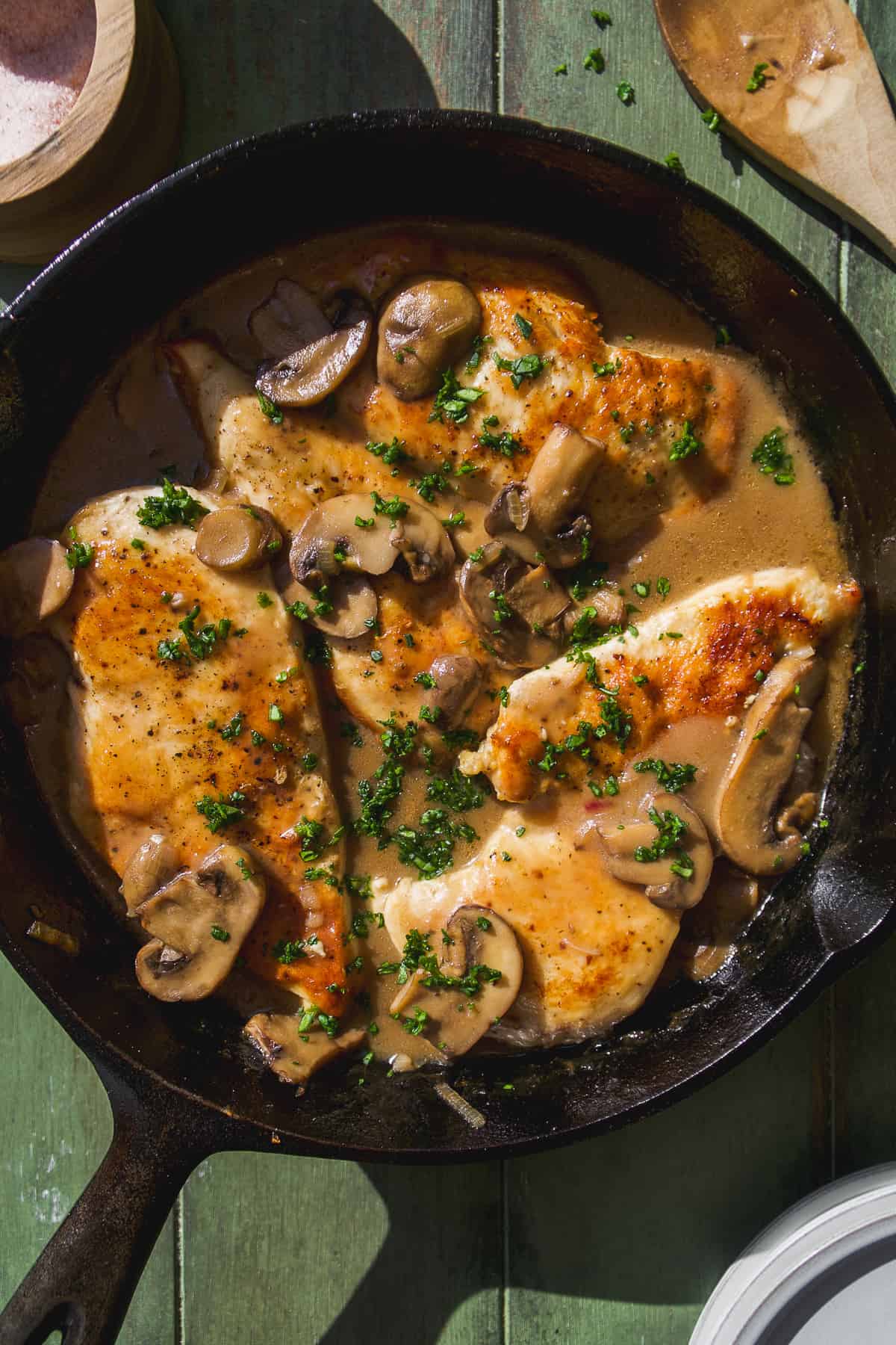 Chicken marsala in a skillet with mushrooms.