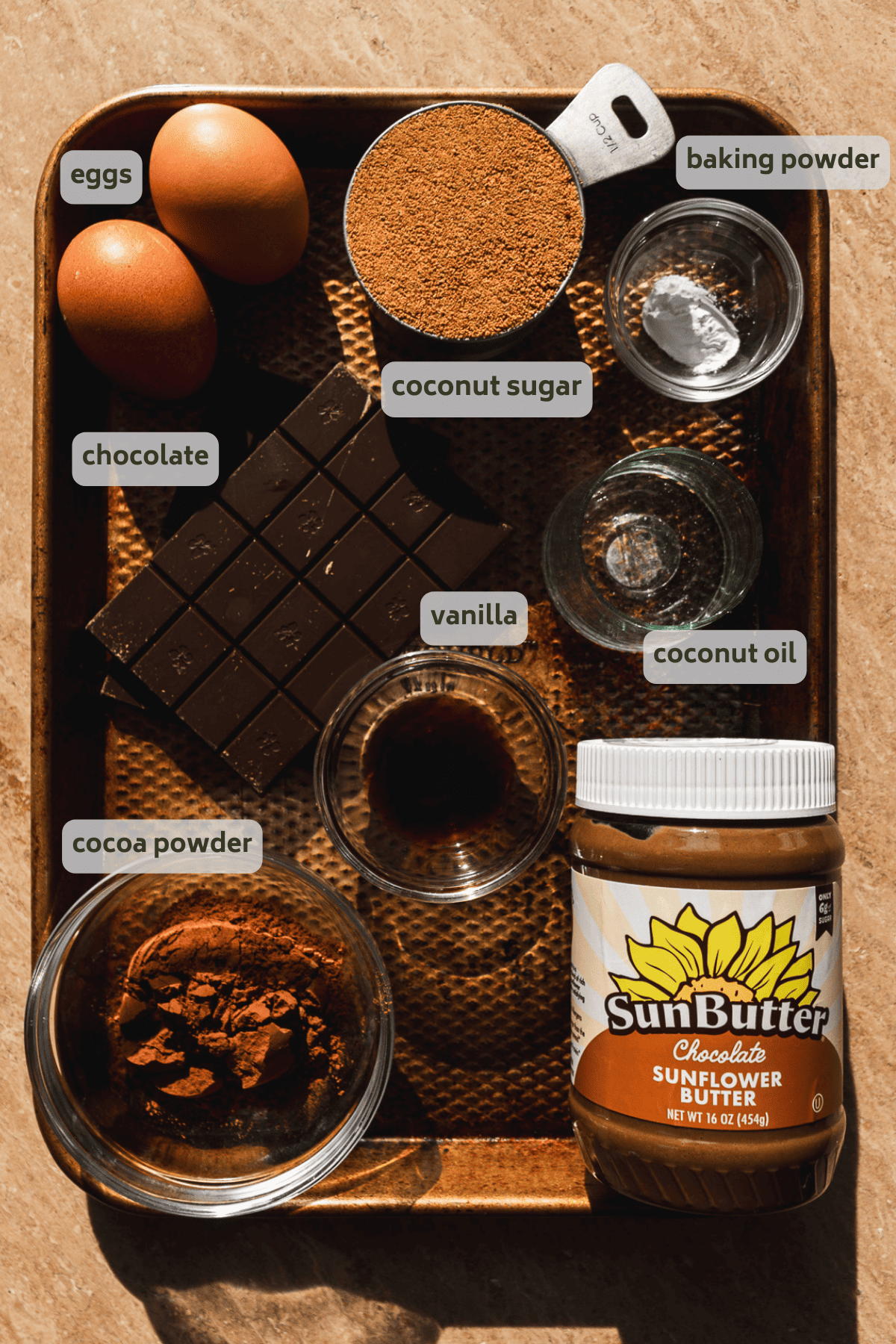 Skillet chocolate cake ingredients on a gold platter with labels.
