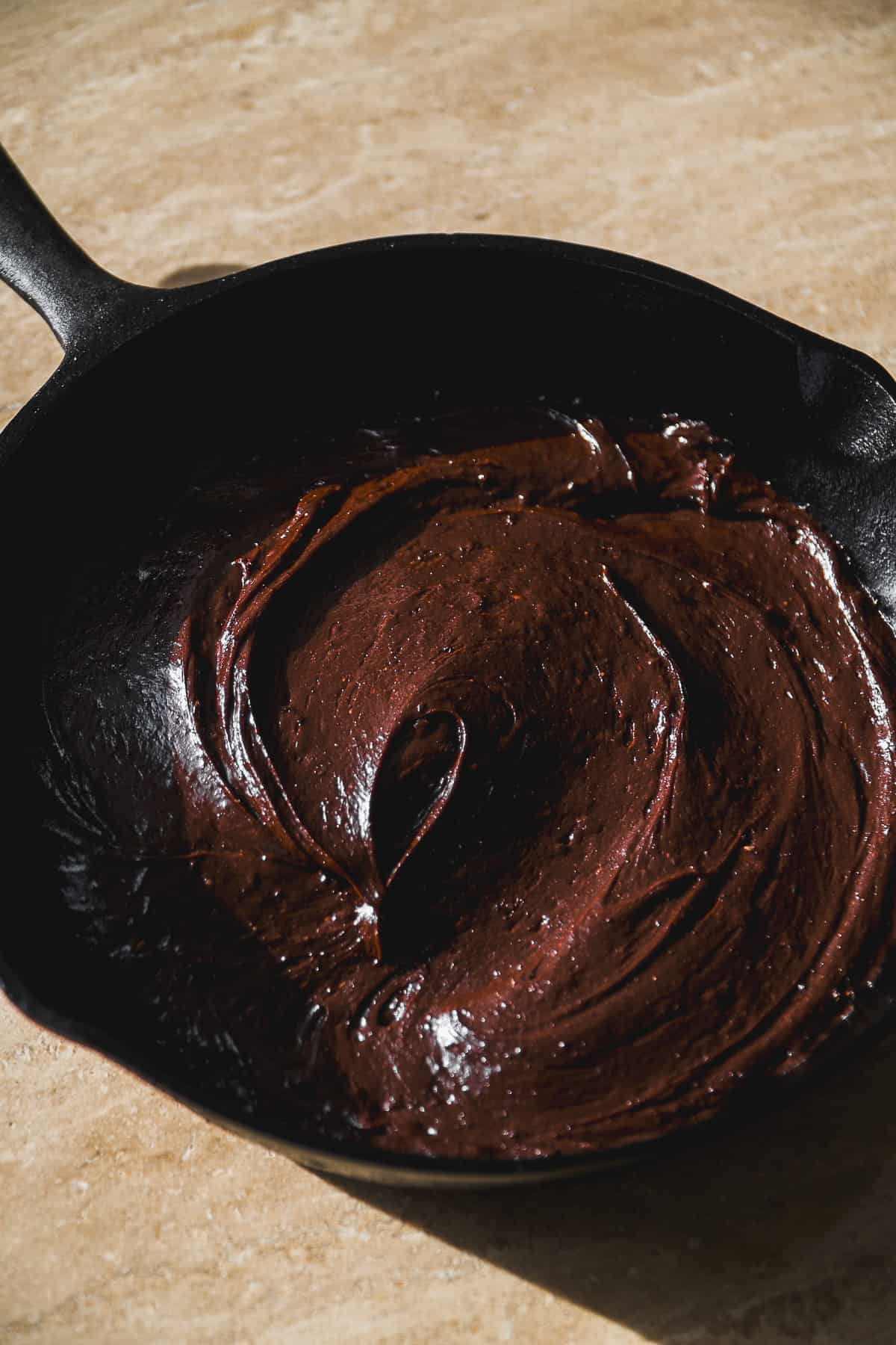 Chocolate flourless cake batter in a skillet.