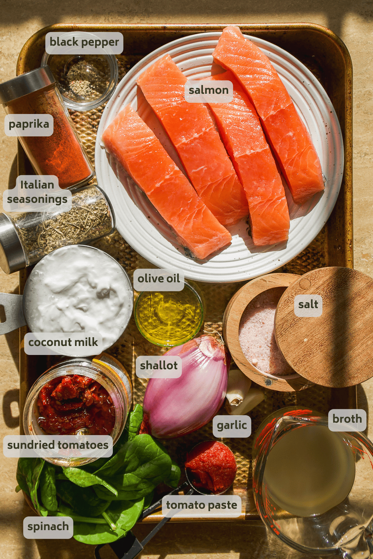 Tuscan salmon ingredients on a baking sheet with labels.