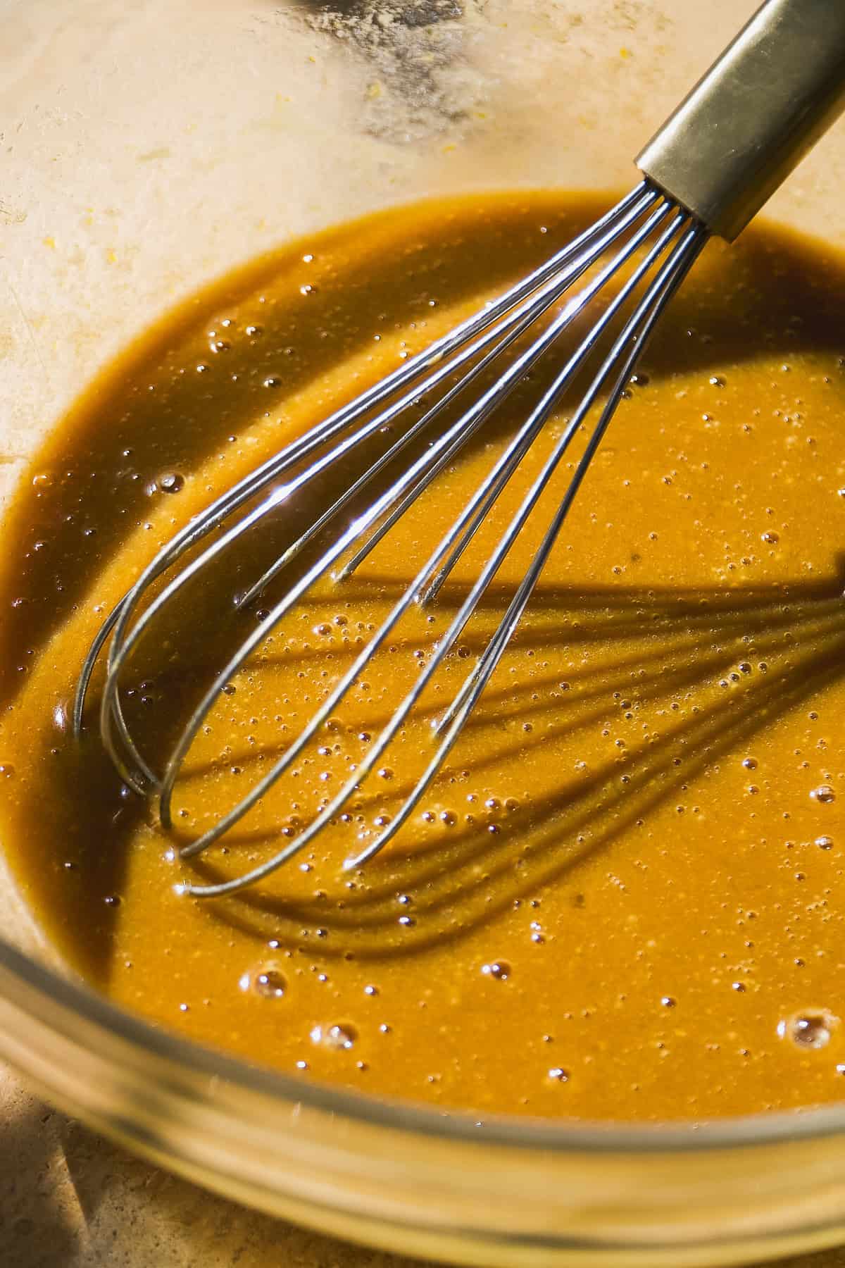 Wet ingredients for oatmeal bars in a glass bowl.