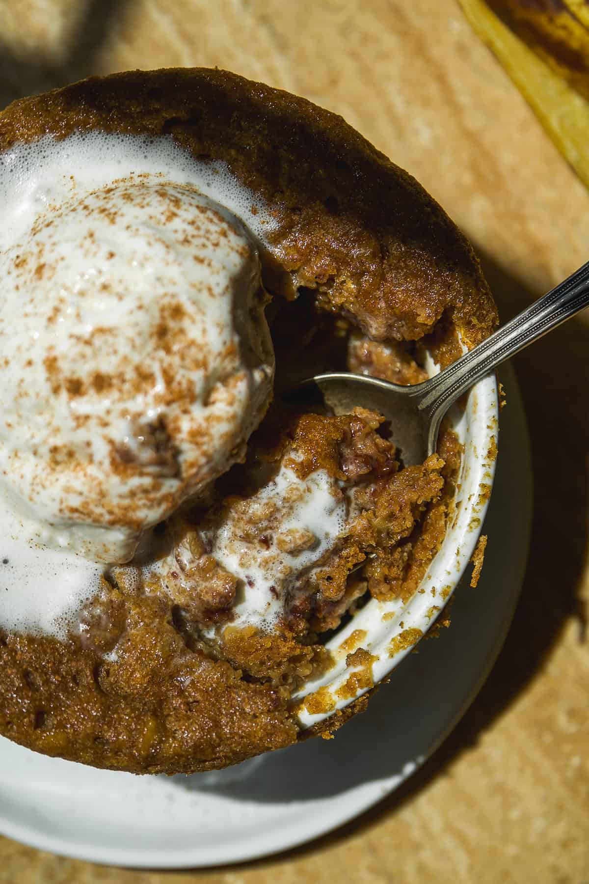 Banana bread mug cake with a spoon inside.