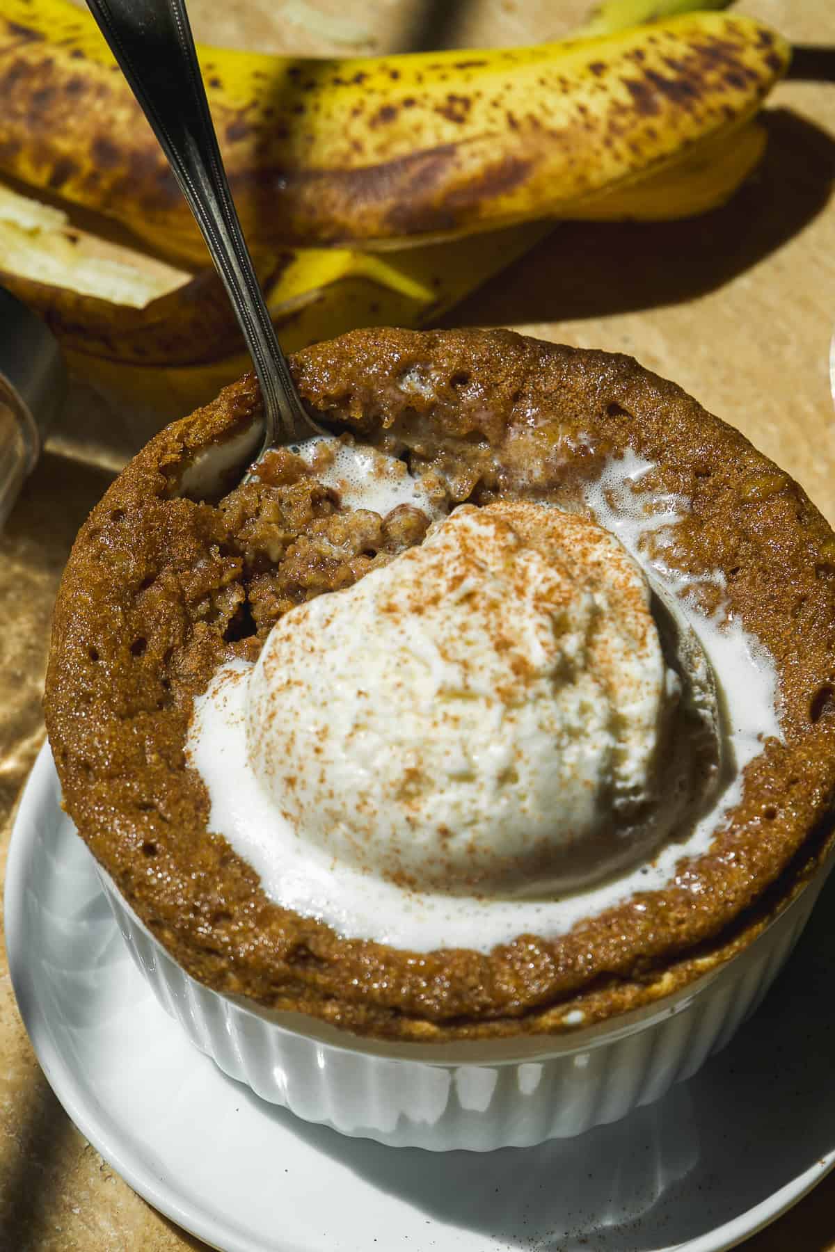 Mug cake with banana and ice crem.