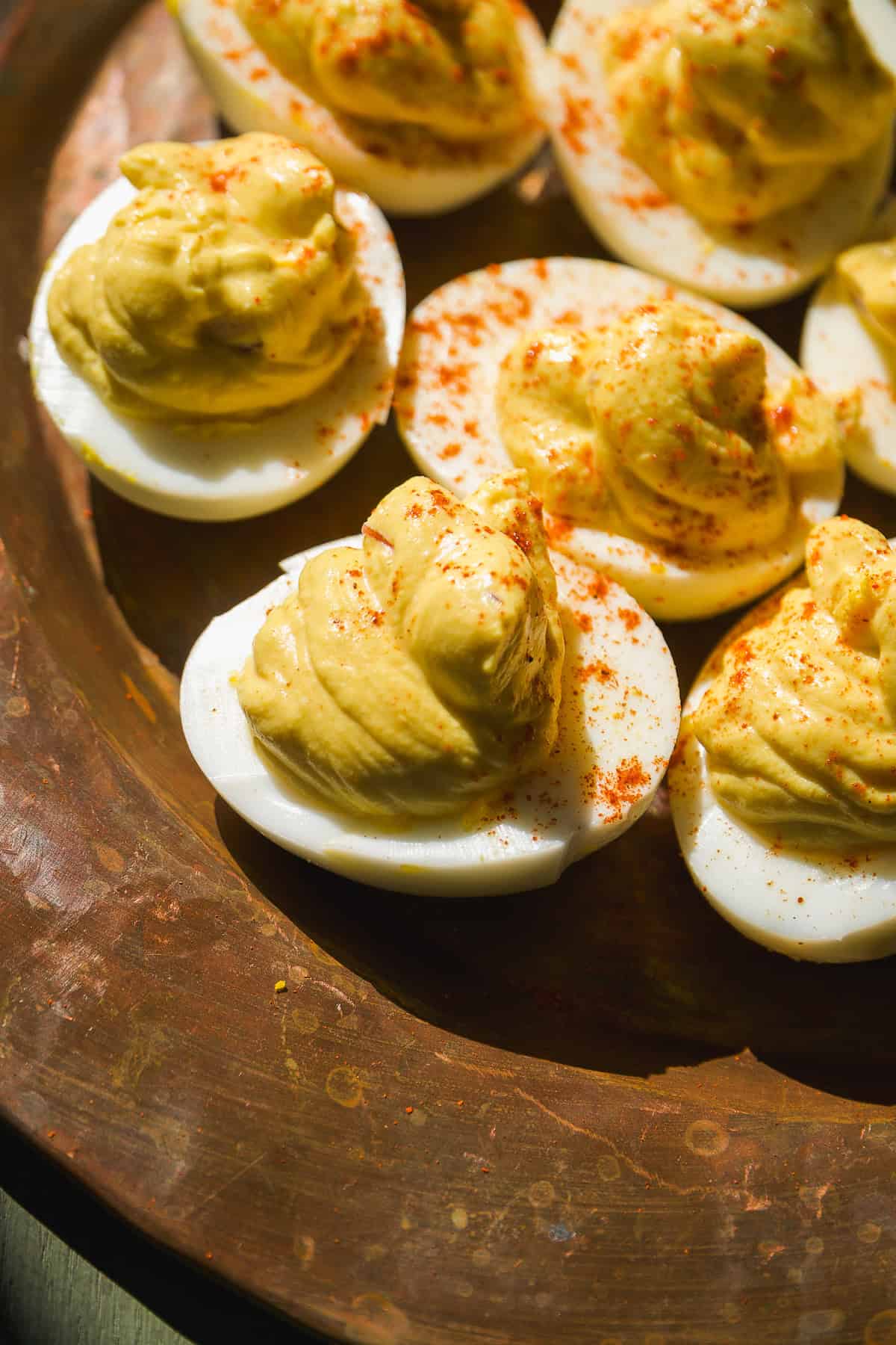 Deviled eggs on a copper platter.