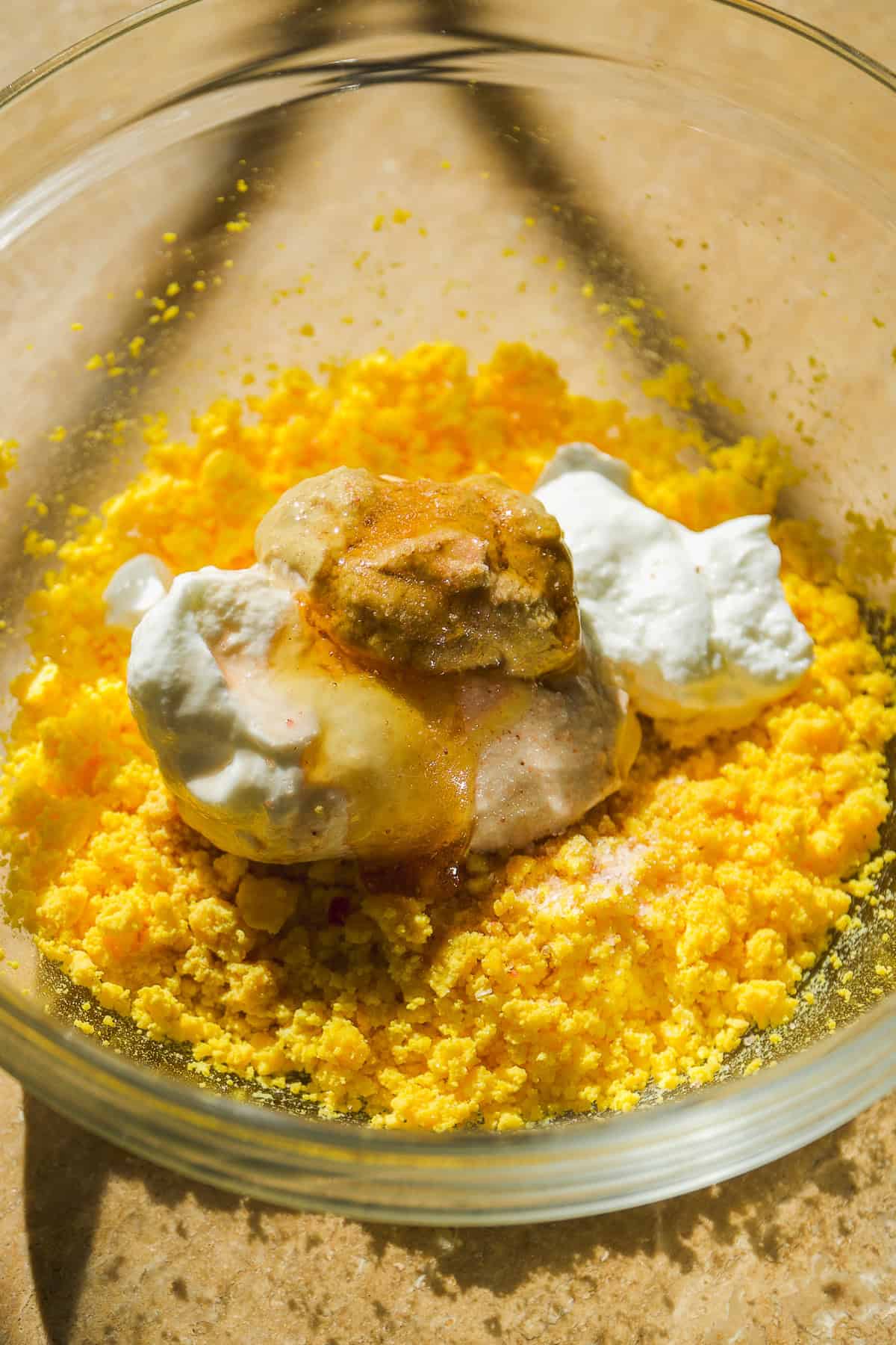 Deviled egg filling about to be mixed in a large bowl.