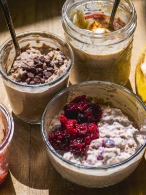 High protein overnight oats in three different flavors in containers.