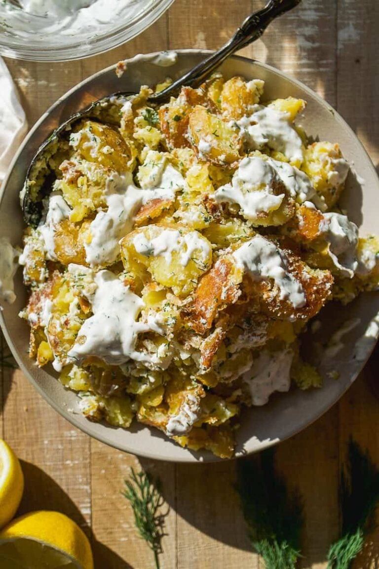 Overhead view of smashed potato salad with yogurt dressing.