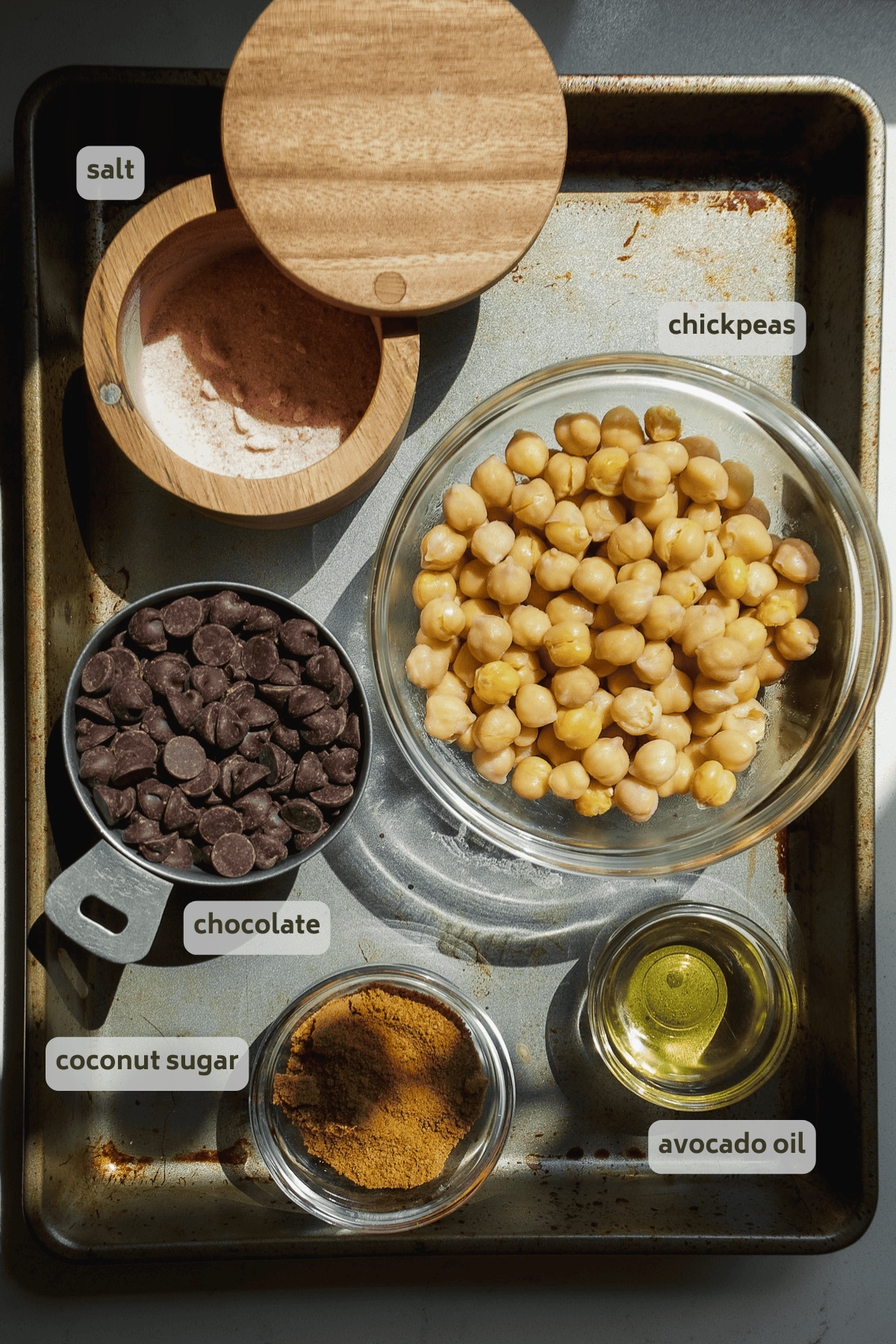 Chocolate covered chickpeas ingredients on a pan with labels.