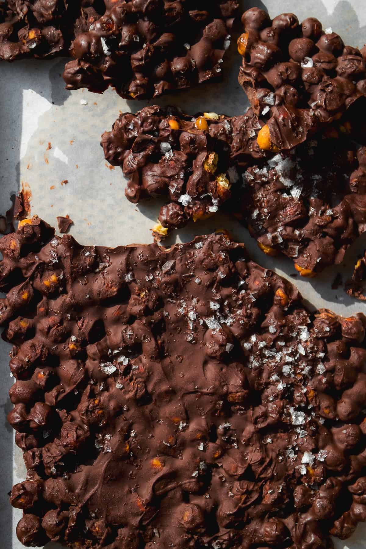 Chocolate chickpeas frozen with sea salt on a pan.