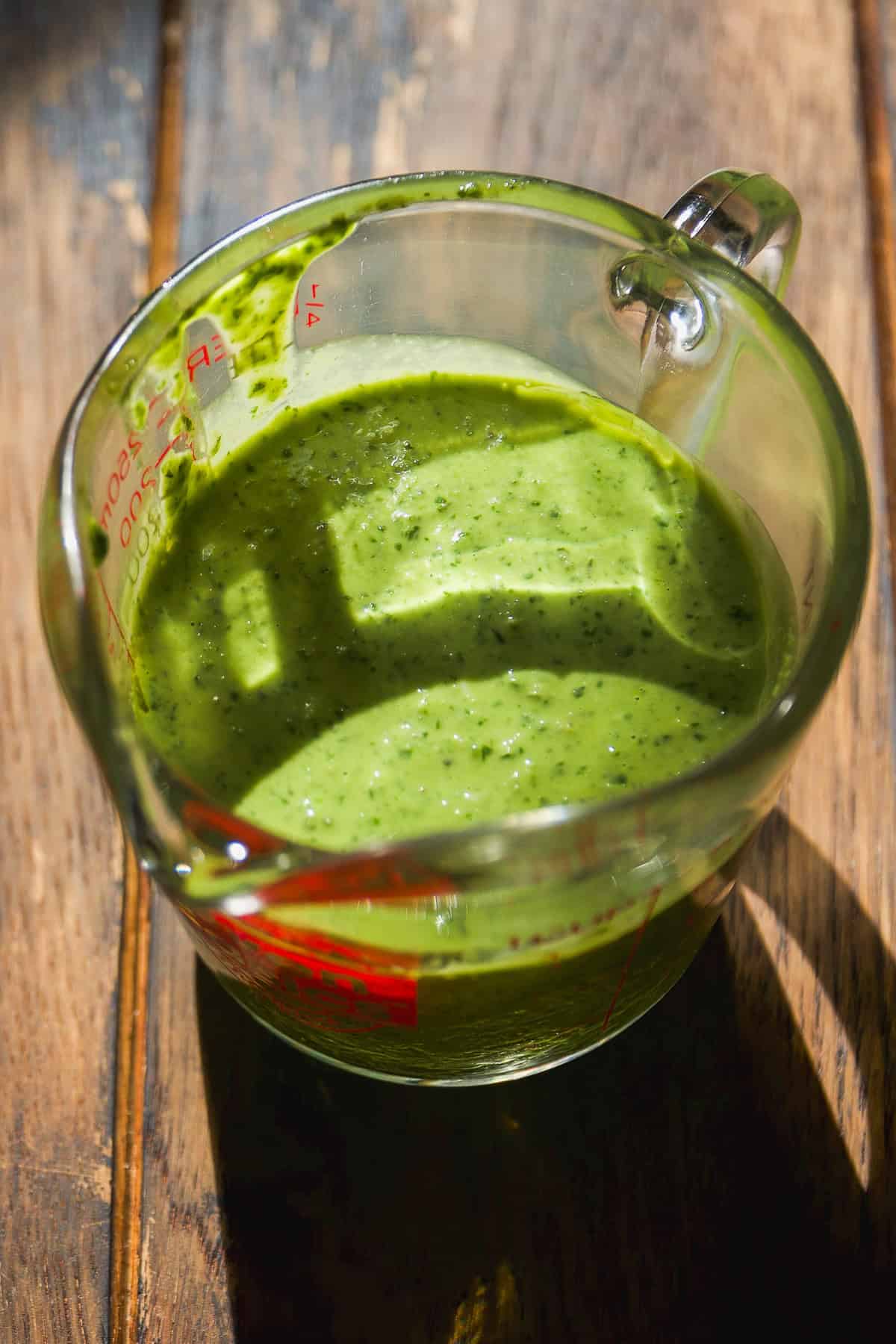 Basil pesto in a glass jar.
