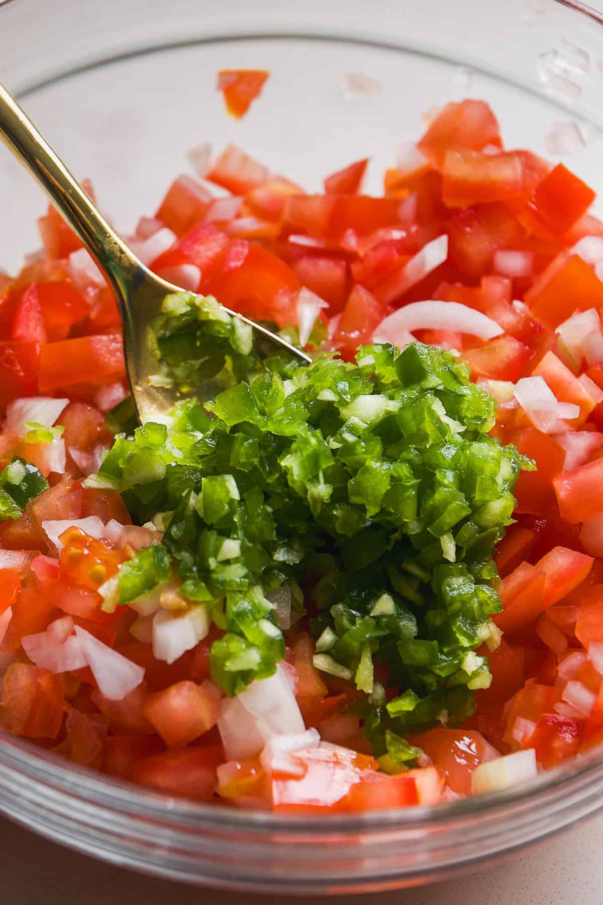 Jalapeno and garlic about to be mixed into tomatoes for pico de gallo.
