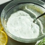 Dill yogurt sauce in a glass bowl.