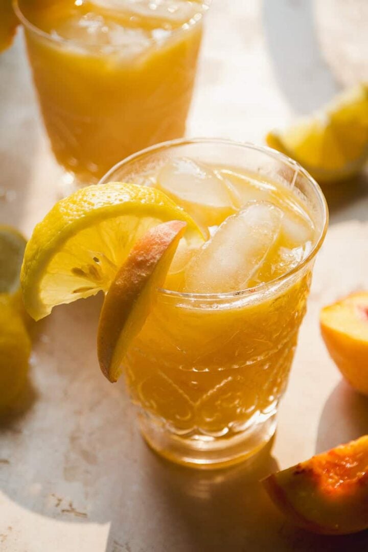 Bourbon Peach Cocktail with peach slices.