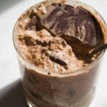 Coffee overnight oats in a glass jar.