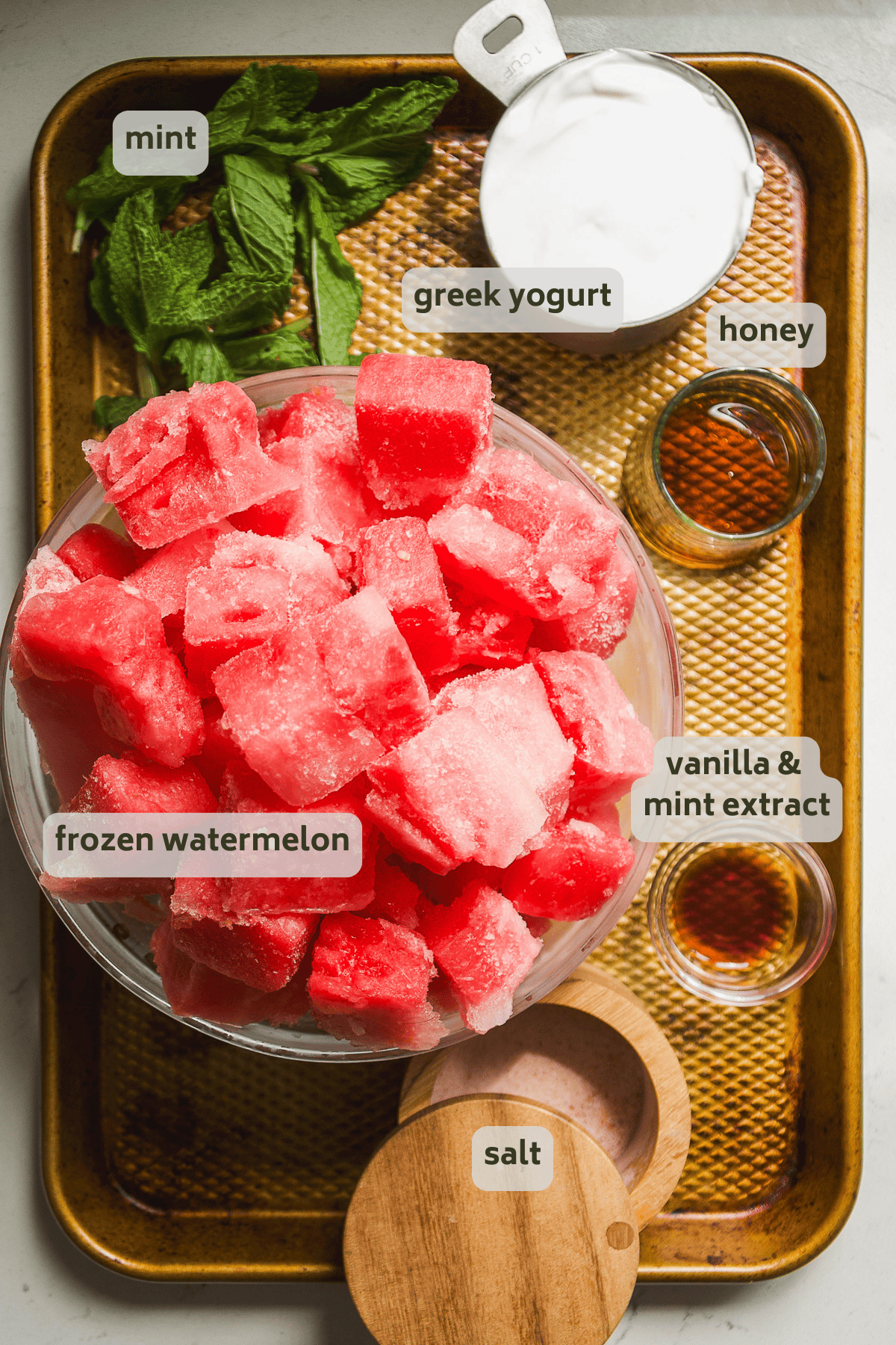 Frozen watermelon ingredients on a pan with labels.
