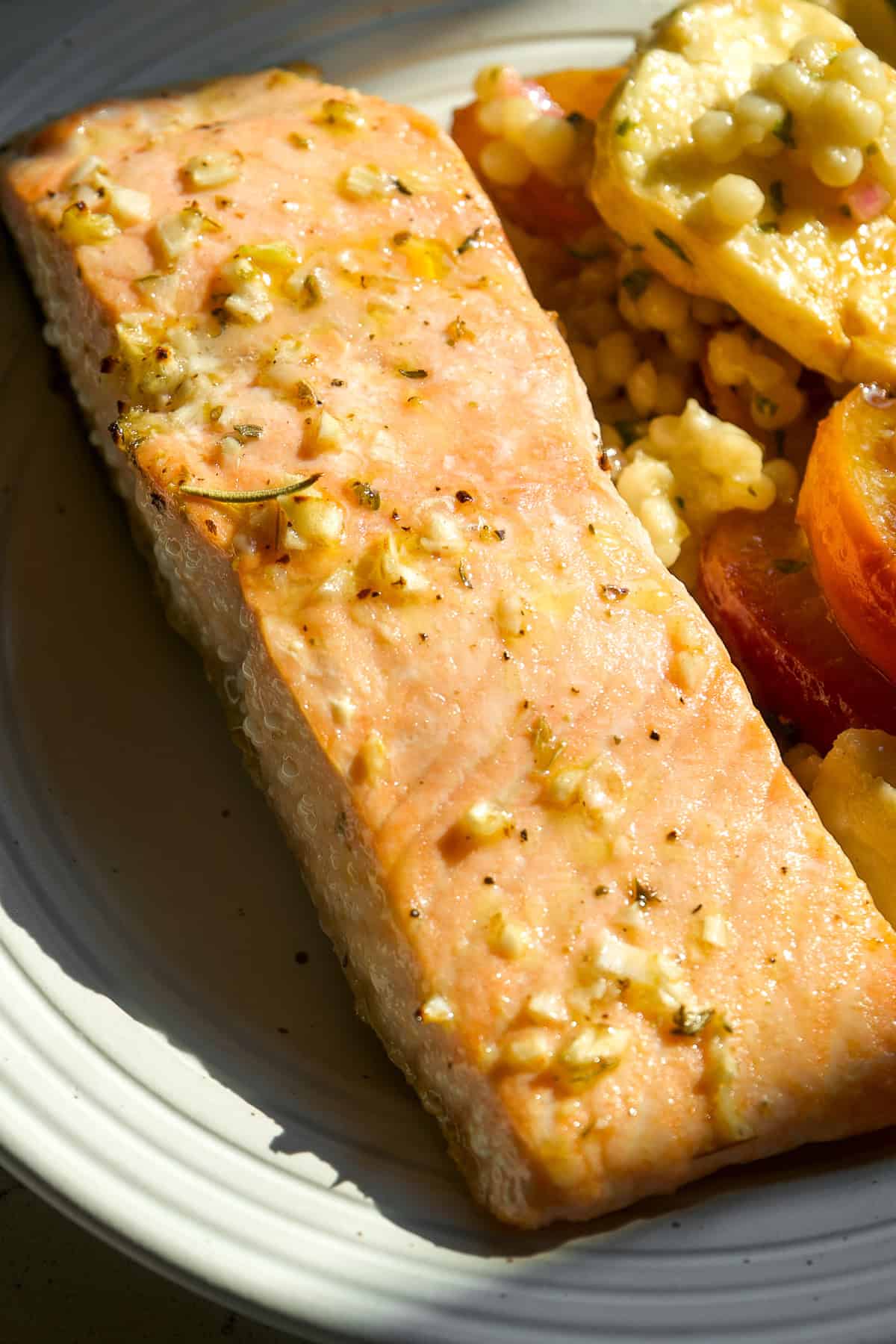 Lemon baked salmon with Italian seasoning on a plate.