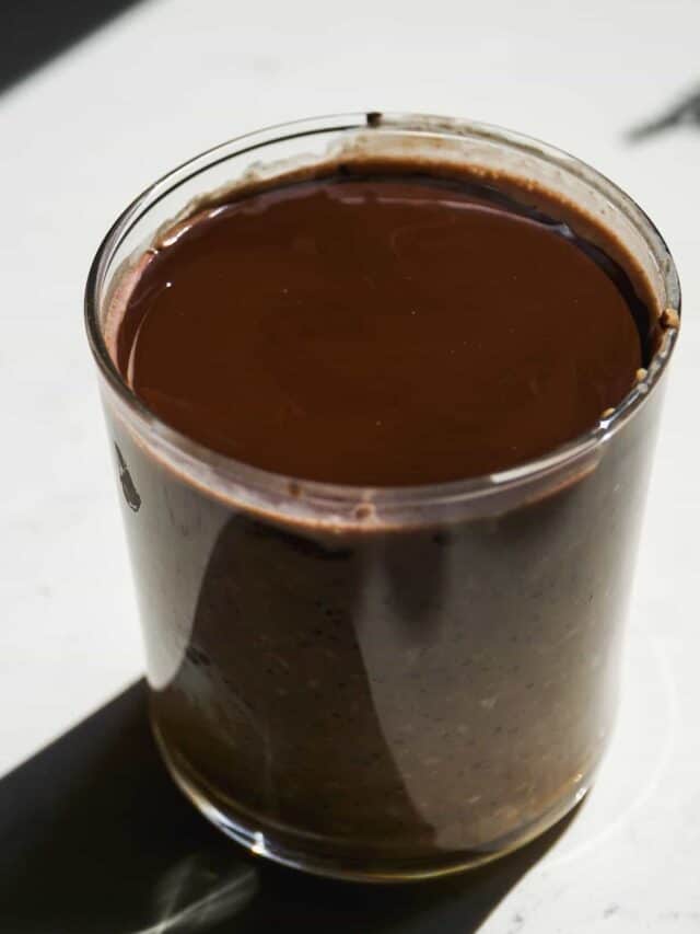 Overhead view of coffee overnight oats with chocolate shell.