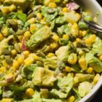 Avocado and corn salad tossed with lettuce and greek yogurt mustard dressing.