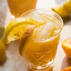 Frozen bourbon peach lemonade in a glass.