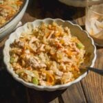 Bowl of egg roll in a bowl with sauce drizzled on top.