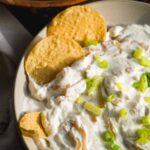 Greek yogurt french onion dip with chips on the side.