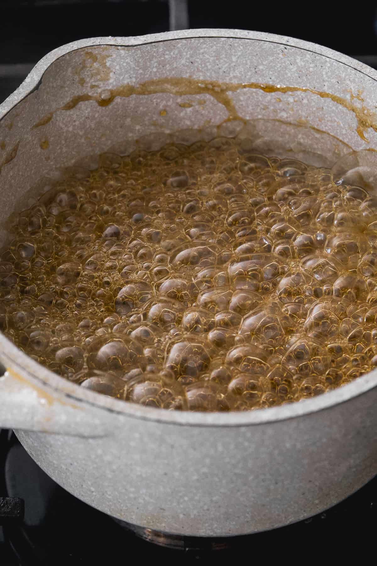 Maple syrup simmering in a pot.