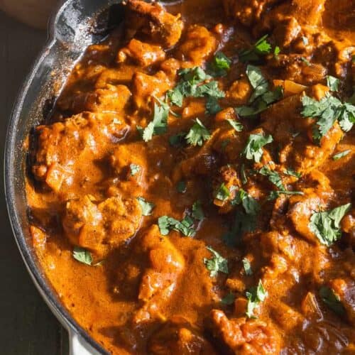 Butter chicken with a tomato curry sauce and cilantro on top.