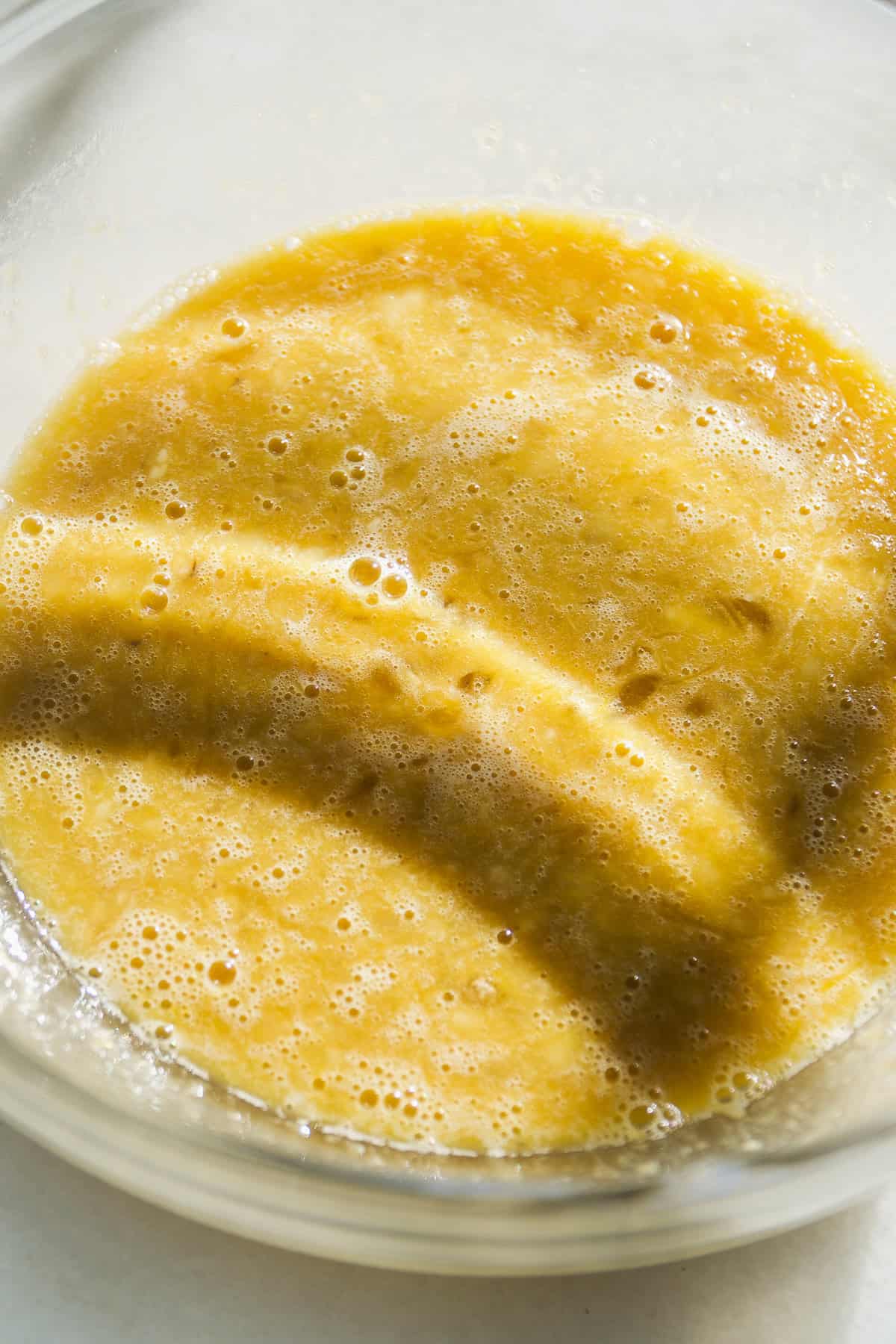 Banana coffee cake wet ingredients in a bowl.