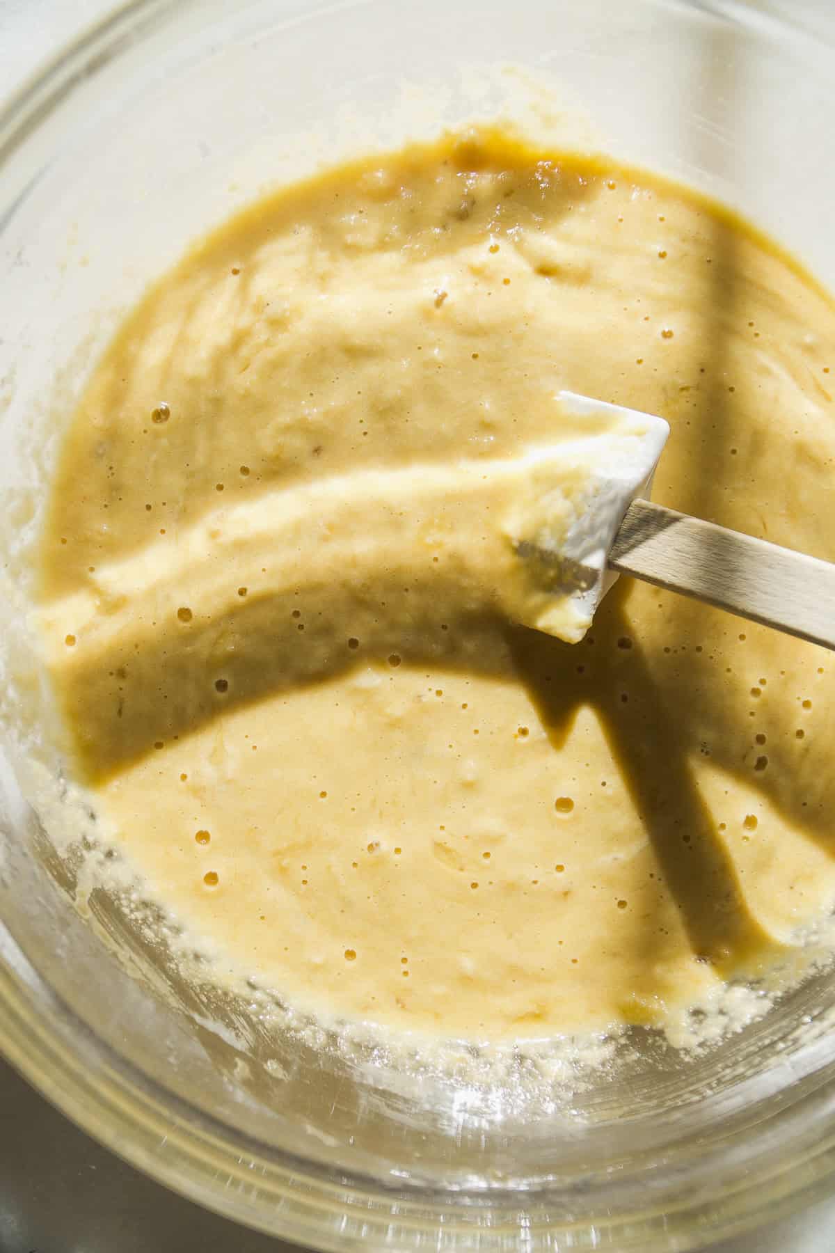 Banana coffee cake batter in a bowl with a spatula.