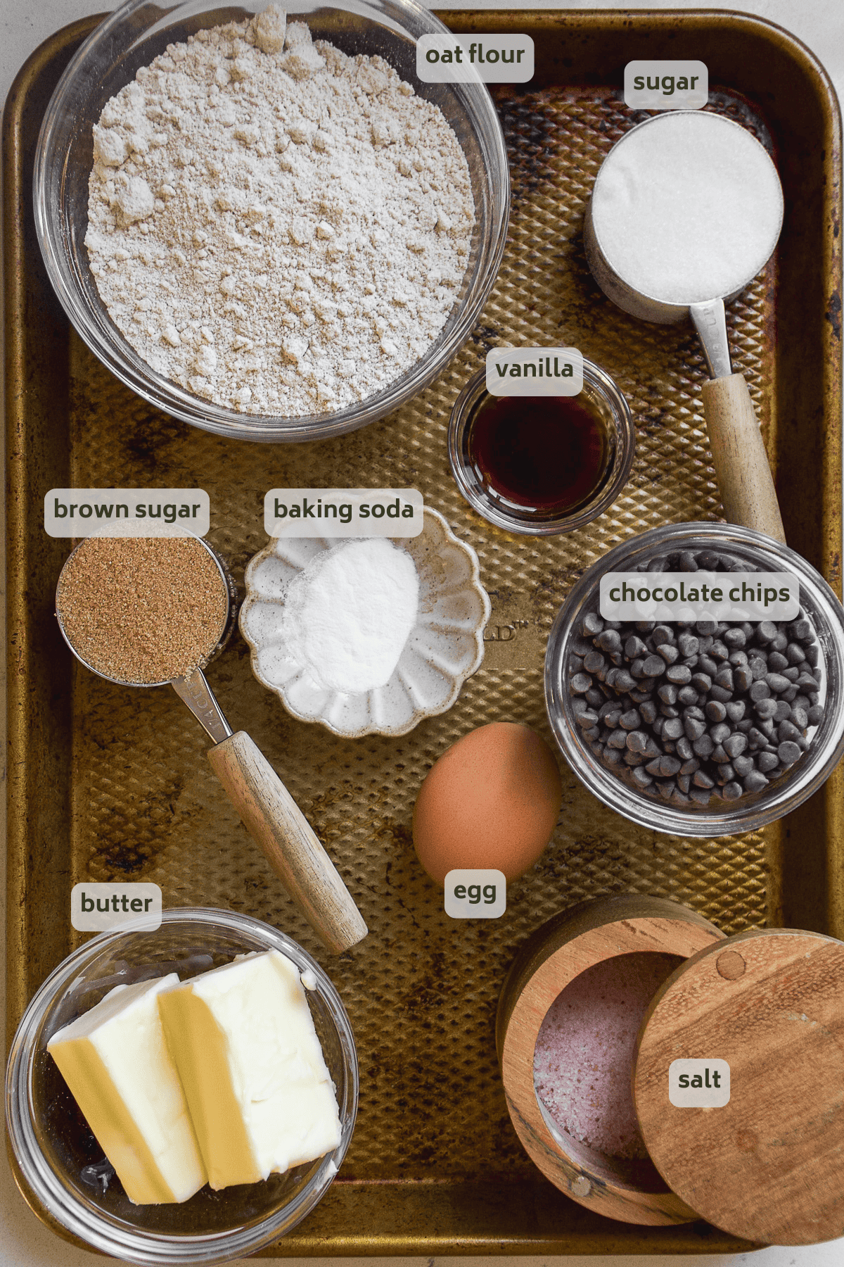 Brown butter chocolate chip cookie ingredients on a pan with labels.