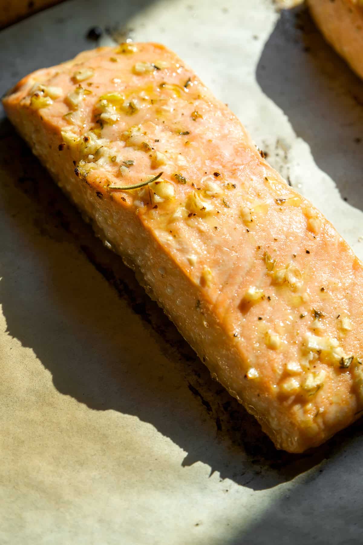 Baked fish fillet topped with minced garlic.