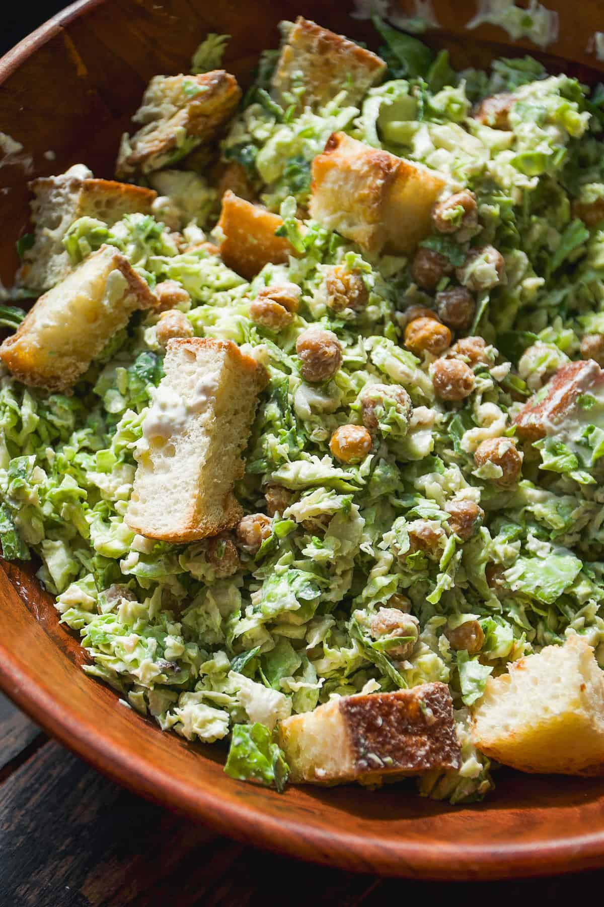 Side salad in a bowl topped with croutons.