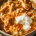 Lasagna soup in a bowl with a dollop of ricotta cheese on top.