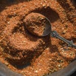 Cajun spice mix in a dish with a spoon.