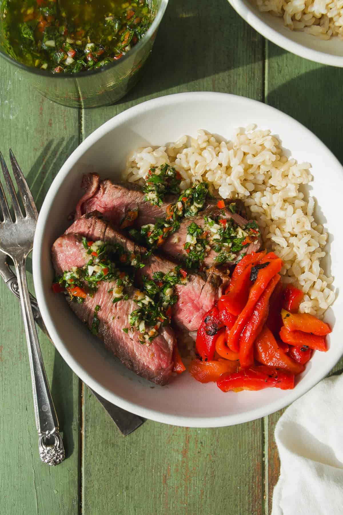 Steak bowls with rice and chimichurri sauce.