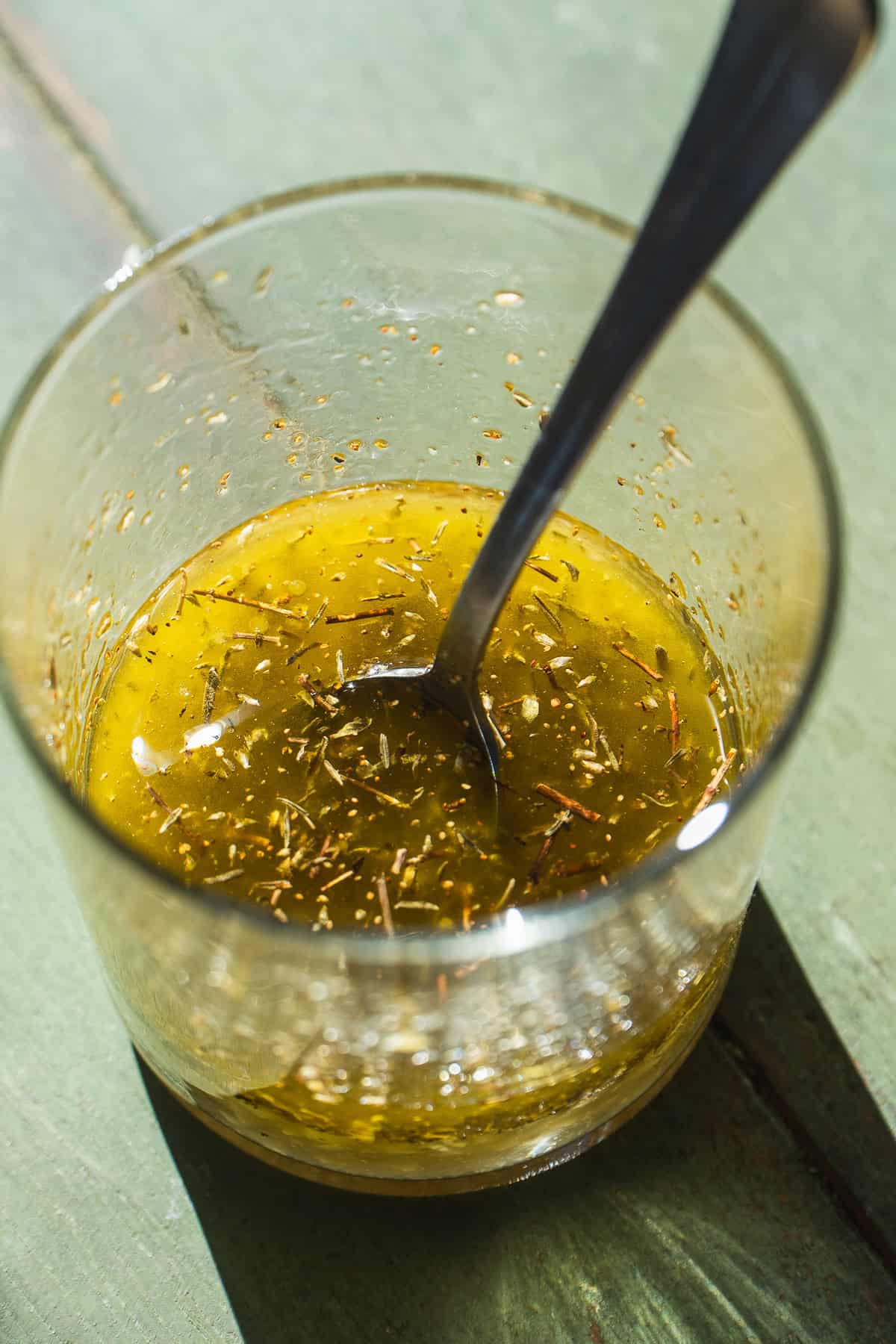 Lemon and herb vinaigrette in a glass jar.
