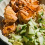 Bang bang salmon bowls with cucumber avocado salad.